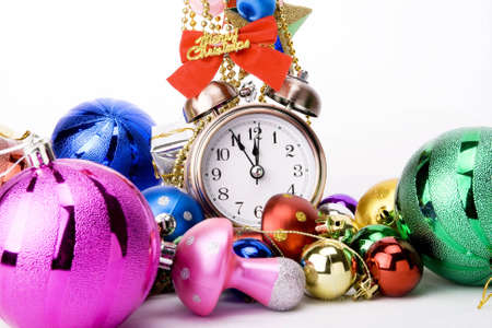 Alarm clock and christmas decorations on a white background