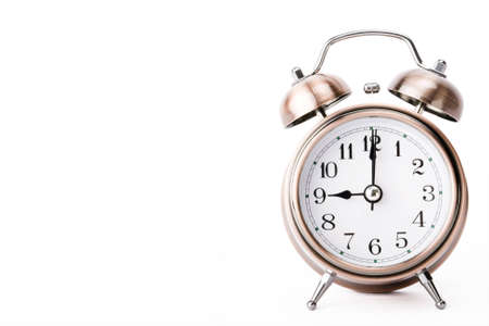 Copper alarm clock showing 9 o'clock side leaving a blankの写真素材