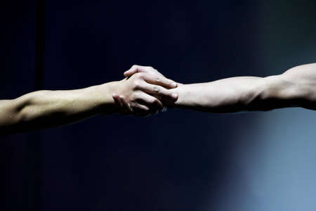 hands wrestling, isolated on black background の写真素材