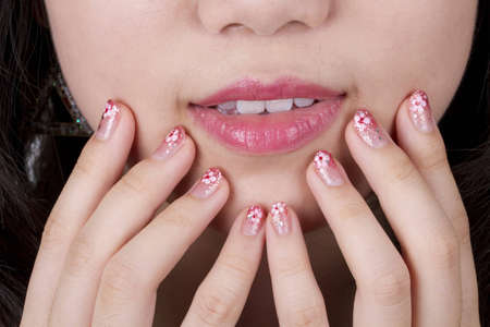 beautiful young woman with red lips and nail artの写真素材