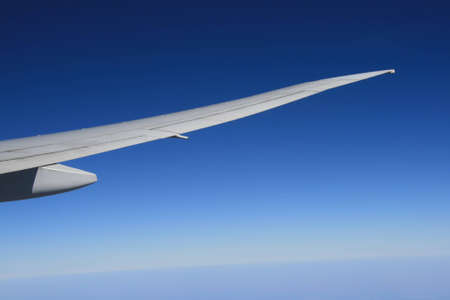 View of jet plane wing on a background of sky