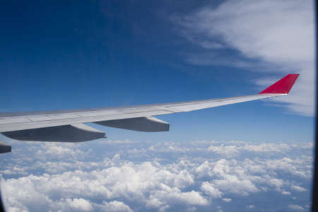 View of jet plane wing on a background of skyの写真素材