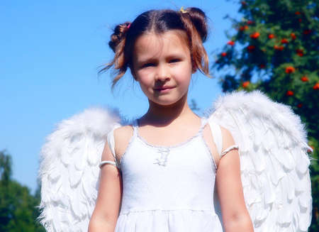child angel wings innocence cleanliness religion red model wood trees grass sky white dress girl childhoodの写真素材