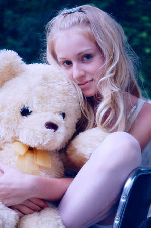 lady hugging a plush bearの写真素材