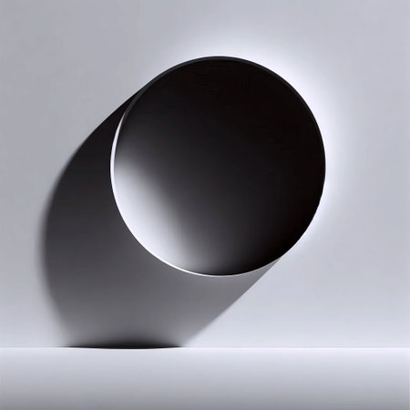 A single, perfectly round porthole window in a curved white wall, casting a crisp circular shadowの写真素材