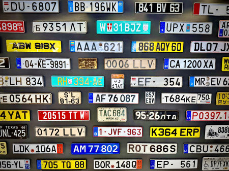 A diverse collection of license plates from various locations displayed on a wall at a car museum. The plates are from different eras and regions, including the U.S., Brazil