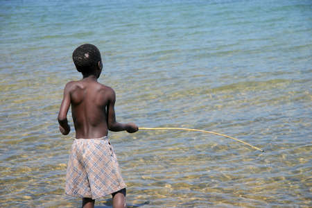 A boy fishing at the Lake Malawiの写真素材