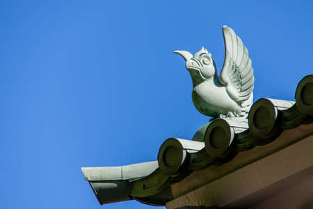 Bird-shaped Ornamental Tile set on top  of Roof