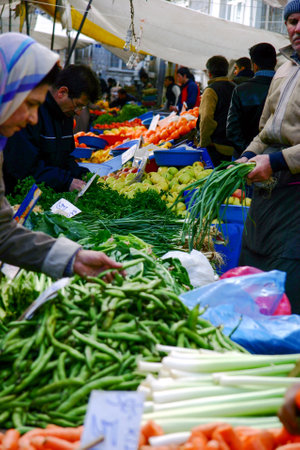Istanbul, Turkey - Mar 15, 2007: People buying and selling vegetables at the open-air marketのeditorial素材