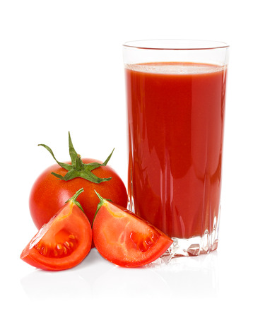 Drinking glass with tomato juice and ripe fresh tomato near isolated on the white backgroundの写真素材