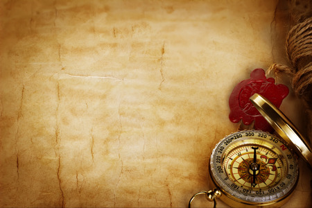 Compass and scroll with wax seal on vintage old paper backgroundの写真素材