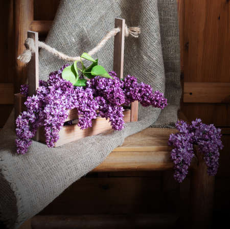 Lilac flowers in a wooden box. Country styleの写真素材