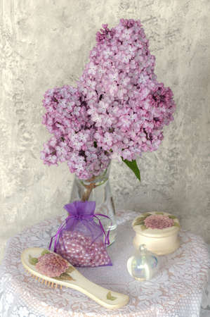 a branch of lilac on the dressing tableの写真素材