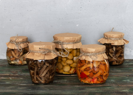 homemade pickled mushrooms in a glass jar. Canned mushrooms close up, organic homemade picklesの写真素材