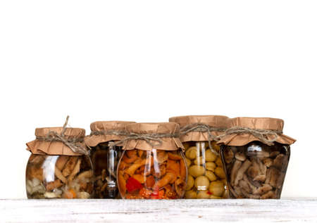homemade pickled mushrooms in a glass jar on White background. Canned mushrooms close up, copy space;の写真素材