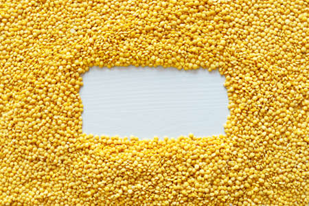 Dried yellow Split Lentils background. Nutritious and Important Protein Source. Flat lay, Copy spaceの写真素材
