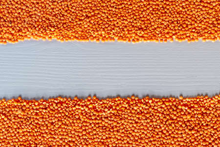 Dried red Split Lentils background. Nutritious and Important Protein Source. Flat lay, texture, Copy spaceの写真素材