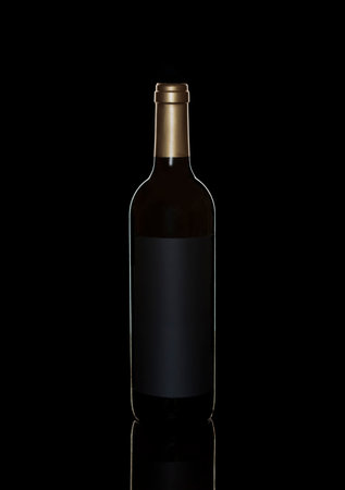 bottle of red wine on black background with reflectionの写真素材