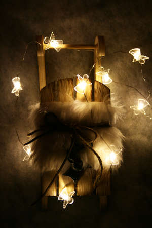 Wooden sleigh with furry blanket and little angels