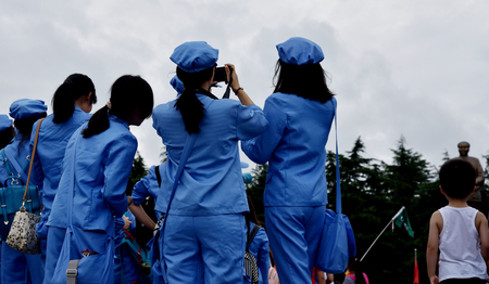 student taking picture at 95 anniversary of the founding of Maoのeditorial素材