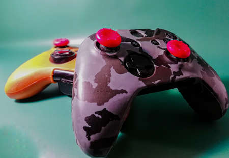 Two game controllers in multi-colored protective casesの写真素材