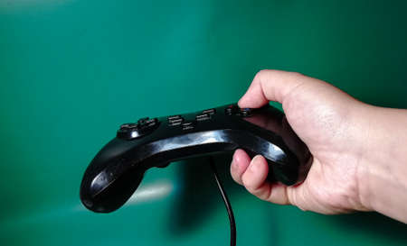 Hand holding a game controlerの写真素材