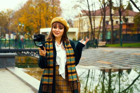 Popular influencer live streaming from park using steadicam and smartphoneの写真素材