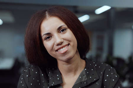 Black businesswoman talking to web camera in office