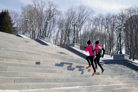 fit people running on stairs in parkの写真素材