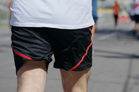 Butt of man running marathon in slow motionの写真素材