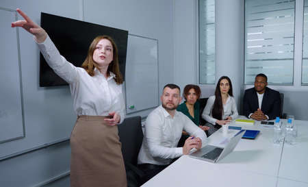 Businesswoman making presentation of new project in officeの写真素材