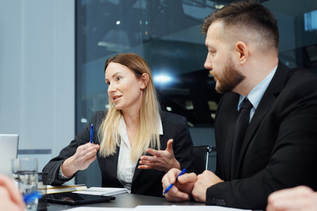 Businesswoman at meeting in office with colleaguesの写真素材