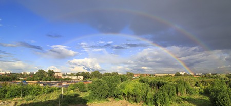 Full beautiful double rainbow over the city.の写真素材