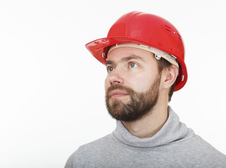 Construction worker in a red helmet on white background.の写真素材