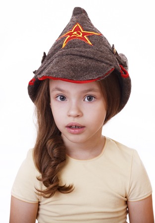 Beautiful little girl in Budenovka on white background.の写真素材