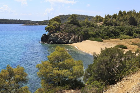 Small bay with a sandy beach on the Aegean Sea. Sithonia peninsula. Greece.の写真素材