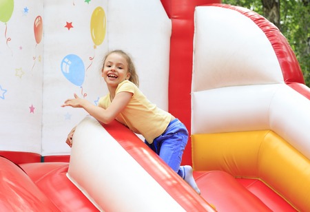 Joyful little girl playing on a trampoline.の写真素材
