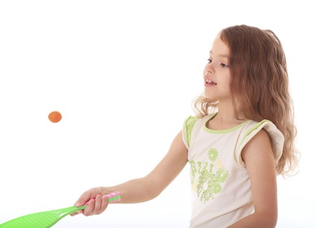 Beautiful little girl playing with a racket and a ball.の写真素材