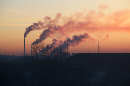 Smoking chimneys above the city at sunrise.の写真素材