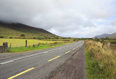 Road with clouds on the hills. Ring of Kerry in Ireland.の写真素材
