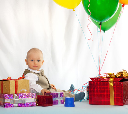 One year old baby with gifts. Day of birth.の写真素材