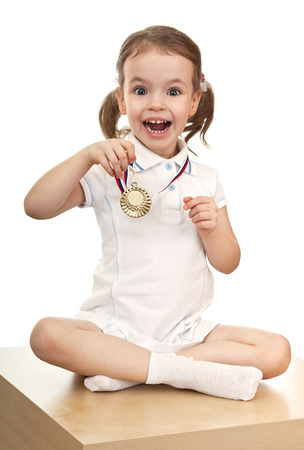 A little girl with a gold medalの写真素材