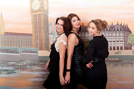 Three gay friends. Beautiful girls. Cheerful parties.の写真素材