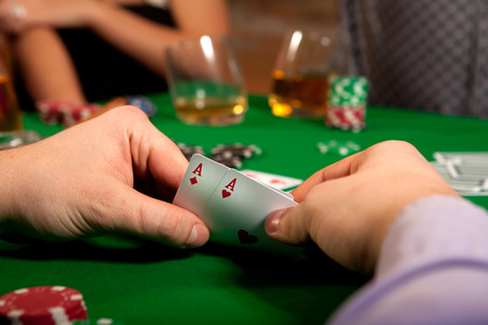 Pair of aces in his hand poker player.