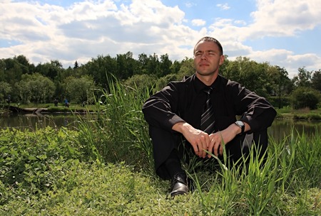 Businessman after difficult negotiations. Solitude on nature.の写真素材