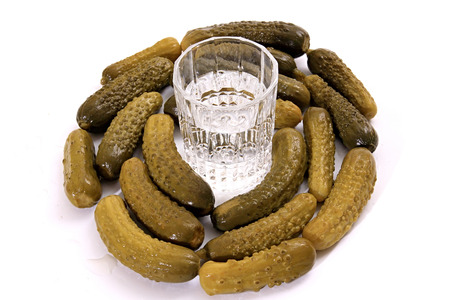 Vodka with the little pickled cucumber. Isolated background.の写真素材