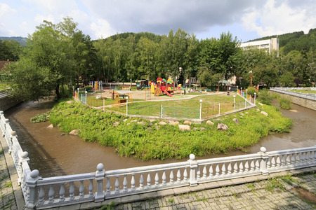 Belokurikha, Russia - July 30, 2013: Playground and river Belokuriha. Sanatorium Centrosouz at the resort Belokuriha.のeditorial素材