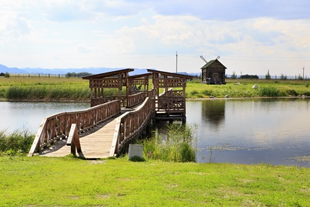 Novotyryshkino, Russia - July 29, 2015: Bridge of love and an old mill. Tourist Complex Siberian Podvorye.のeditorial素材