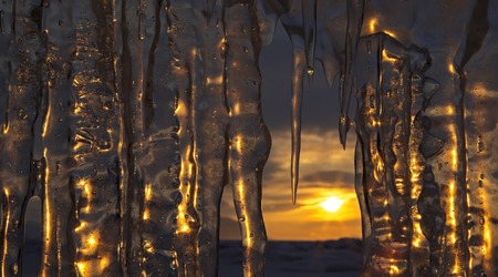 Setting sun is reflected in icicles. Beautiful winter landscape in the Lake Baikal.の写真素材