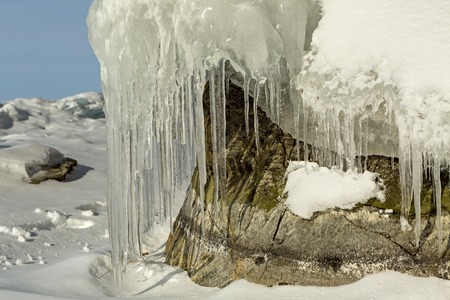 Beautiful icicles on rocks. Winter landscape in the Lake Baikal.